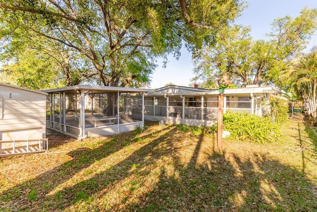 back of property with a sunroom