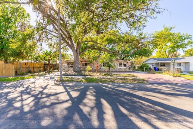 view of front of property with driveway and fence