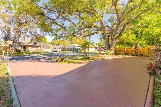 exterior space with driveway, fence, and a residential view