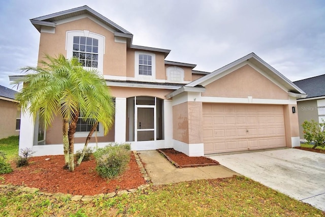 traditional home featuring a garage, driveway, and stucco siding