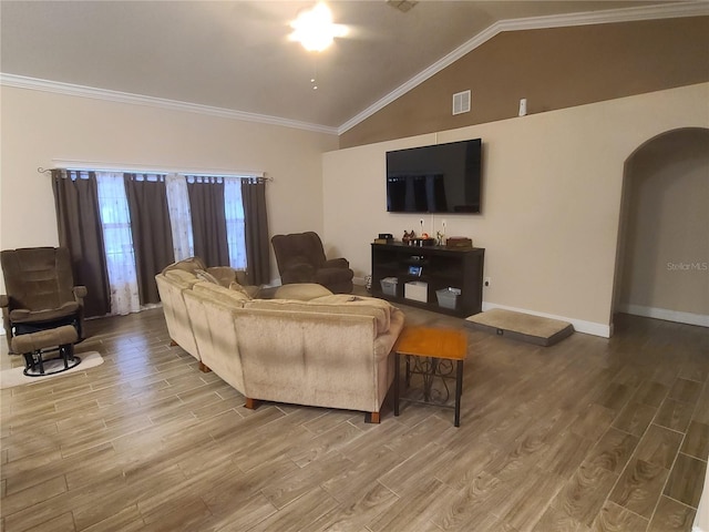 living room with wood finished floors, visible vents, arched walkways, ornamental molding, and vaulted ceiling