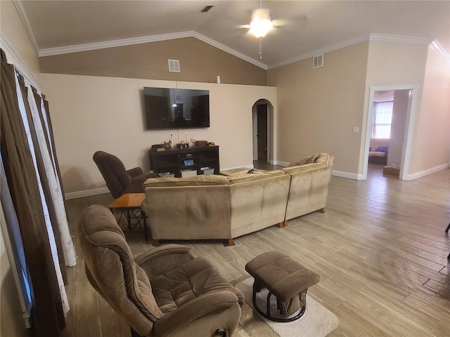 living area featuring light wood-type flooring, visible vents, and arched walkways