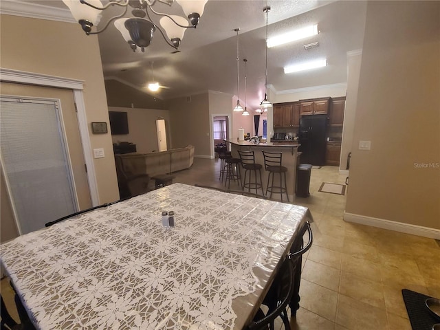 dining room featuring visible vents, ornamental molding, an inviting chandelier, light tile patterned floors, and vaulted ceiling