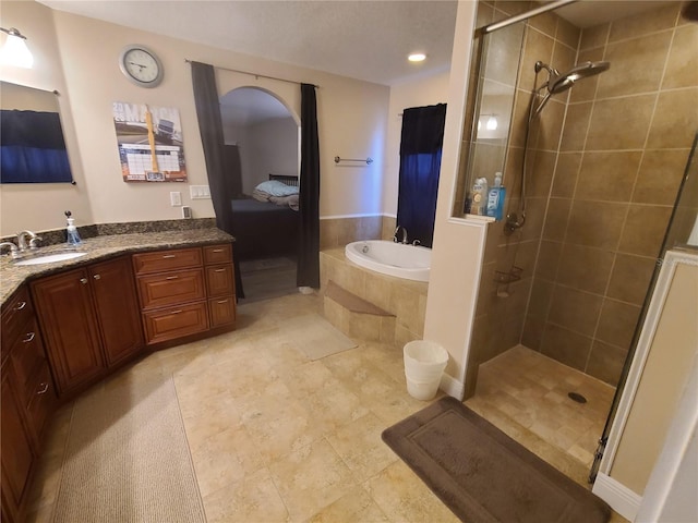 full bath with a bath, tile patterned flooring, a shower stall, and vanity