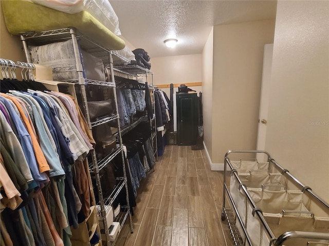 walk in closet featuring wood tiled floor