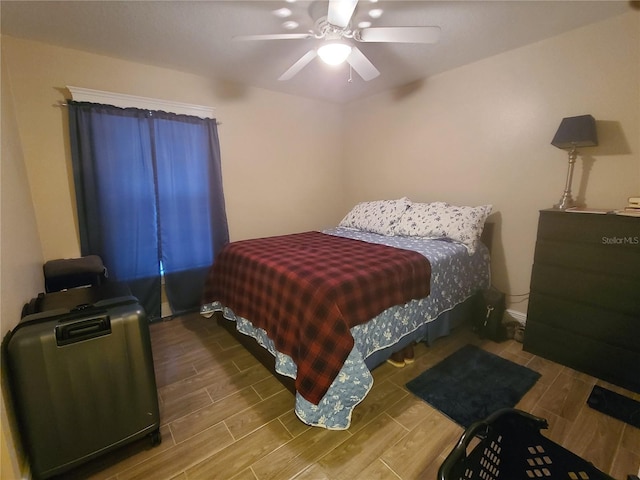 bedroom featuring a ceiling fan and wood tiled floor