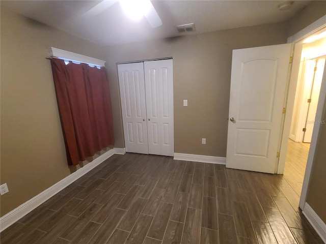 unfurnished bedroom featuring baseboards, visible vents, and wood tiled floor