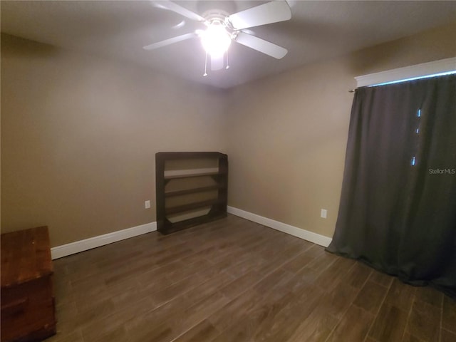 unfurnished bedroom featuring ceiling fan, baseboards, and wood finished floors