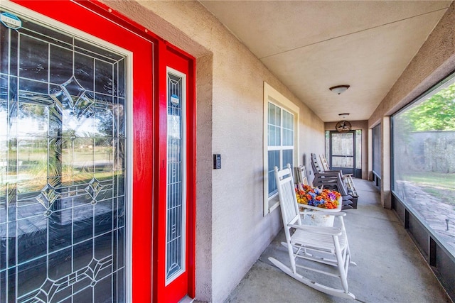 entrance to property featuring stucco siding