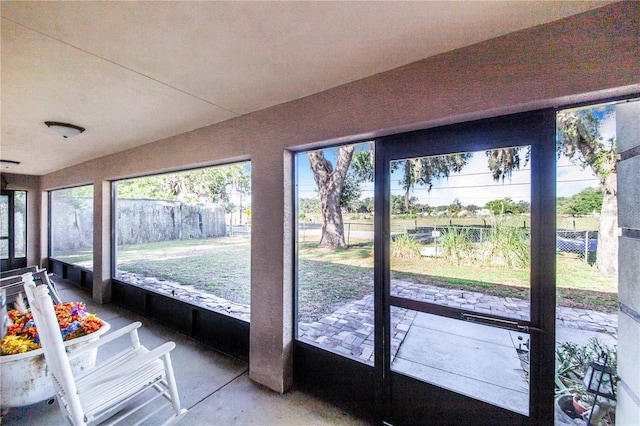 sunroom / solarium with concrete flooring