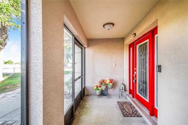 entrance to property with stucco siding