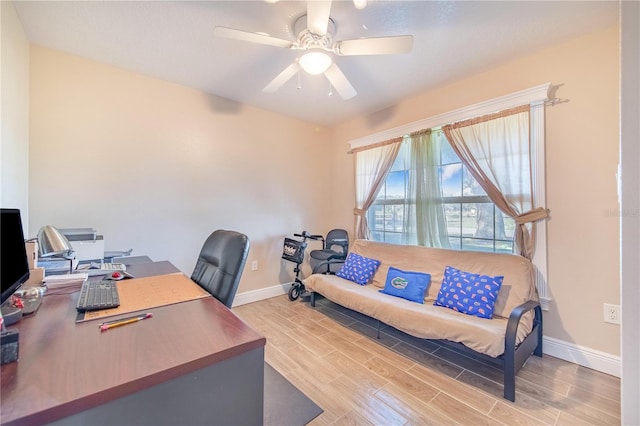 office featuring a ceiling fan, wood finish floors, and baseboards