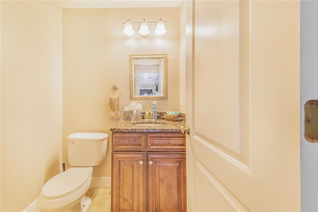 bathroom featuring baseboards, toilet, tile patterned flooring, and vanity