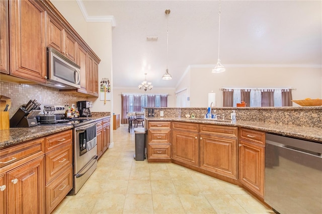 kitchen featuring decorative backsplash, ornamental molding, brown cabinets, dark stone counters, and appliances with stainless steel finishes