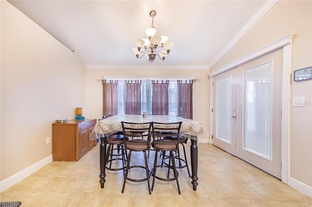 dining room featuring an inviting chandelier, ornamental molding, baseboards, and french doors