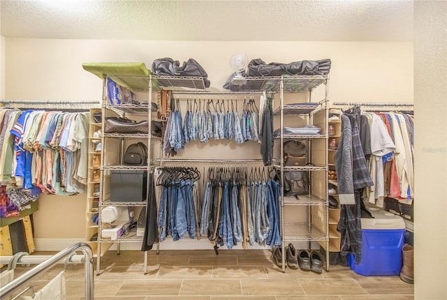 spacious closet with wood finish floors