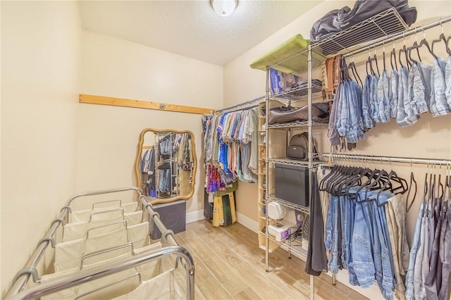 walk in closet featuring wood finish floors