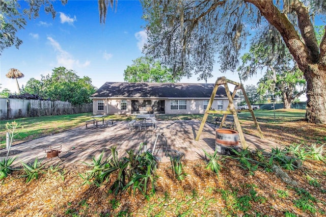 back of house with fence and a yard
