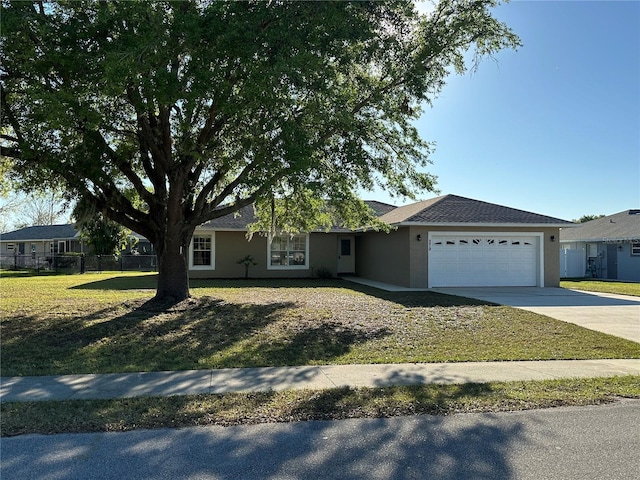 ranch-style house with a garage, fence, concrete driveway, stucco siding, and a front lawn