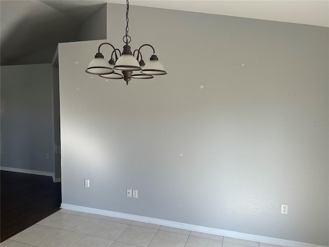 unfurnished dining area featuring a chandelier, baseboards, and light tile patterned floors