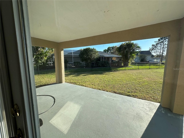 view of patio / terrace featuring glass enclosure and fence