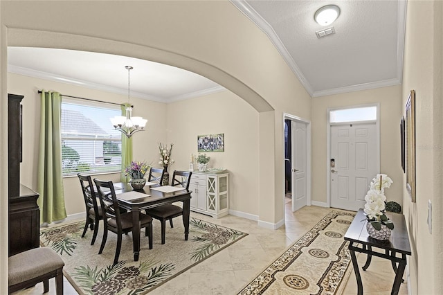 dining area featuring visible vents, a notable chandelier, ornamental molding, arched walkways, and baseboards