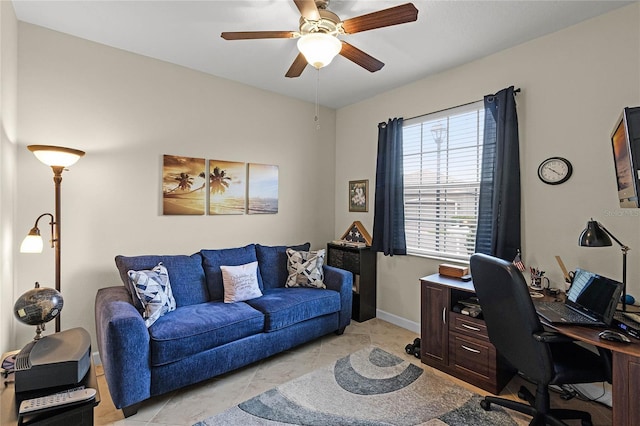 office space featuring a ceiling fan and baseboards