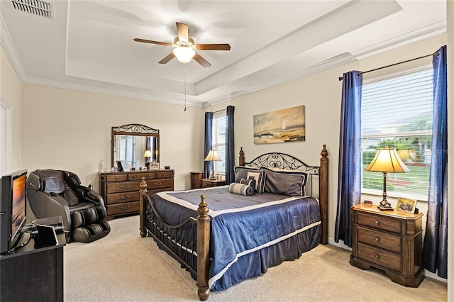 bedroom with visible vents, light carpet, ornamental molding, a ceiling fan, and a raised ceiling