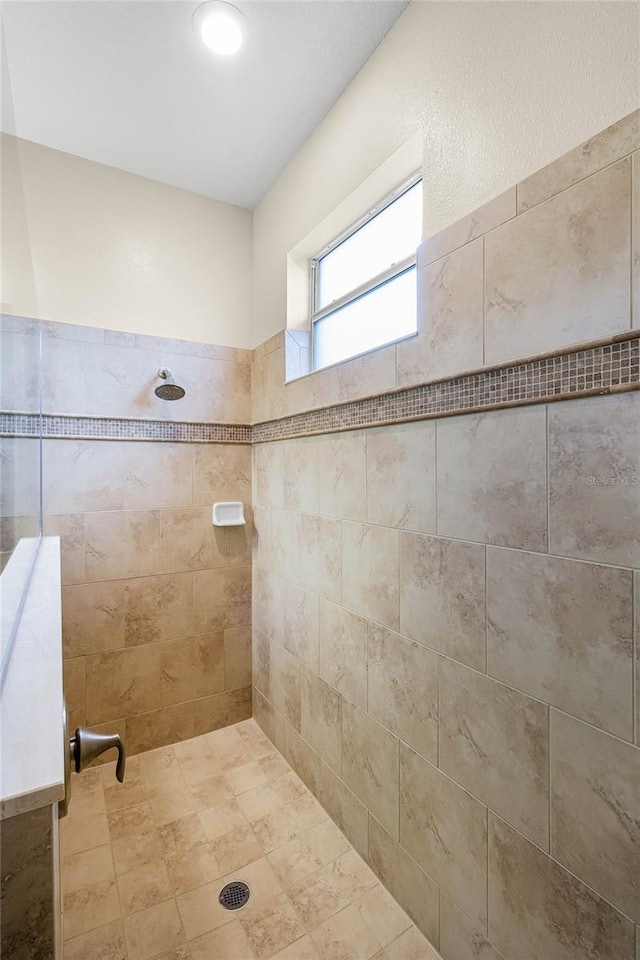 bathroom with tiled shower