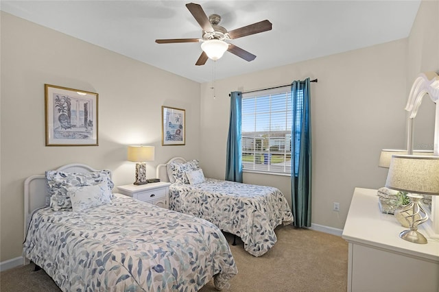 bedroom featuring baseboards, light carpet, and ceiling fan