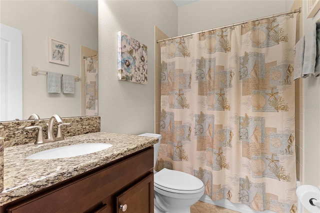 bathroom featuring vanity, a shower with shower curtain, toilet, and tile patterned flooring
