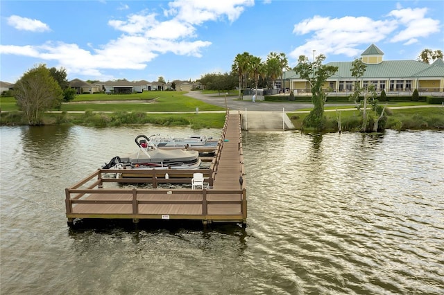 dock area featuring boat lift and a water view