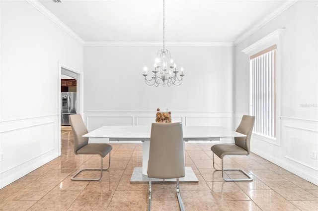 tiled dining space featuring ornamental molding, a decorative wall, a wealth of natural light, and an inviting chandelier
