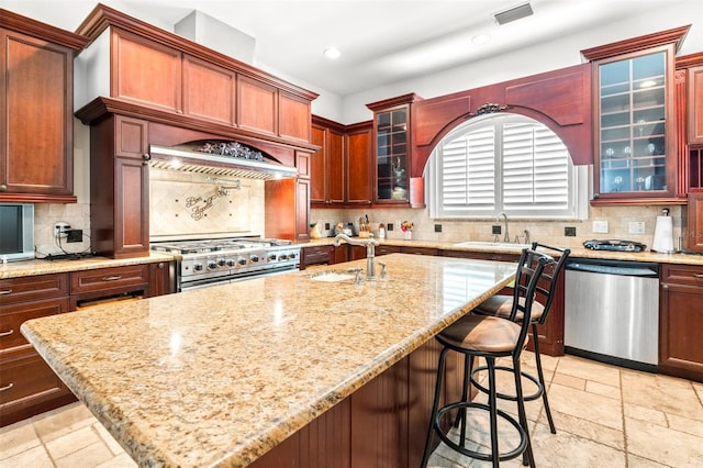 kitchen featuring appliances with stainless steel finishes, stone tile flooring, visible vents, and a sink