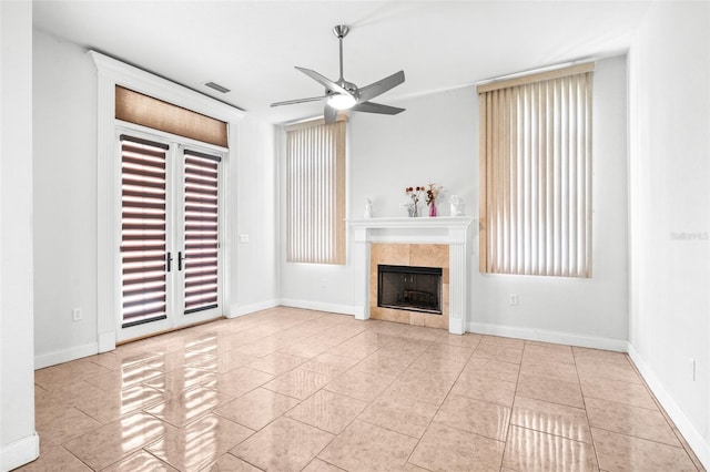 unfurnished living room featuring baseboards, visible vents, ceiling fan, tile patterned flooring, and a fireplace