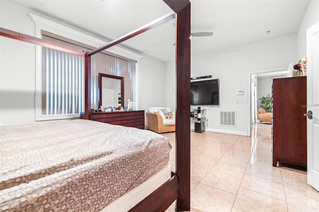 bedroom featuring light tile patterned floors, baseboards, visible vents, and ceiling fan