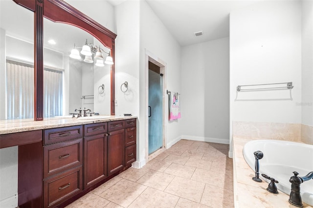 bathroom featuring a garden tub, visible vents, baseboards, vanity, and tile patterned floors
