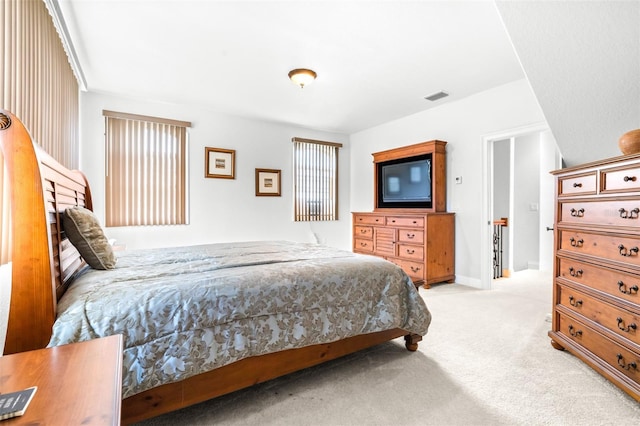 carpeted bedroom featuring visible vents and baseboards