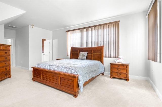 bedroom featuring light carpet, visible vents, and baseboards