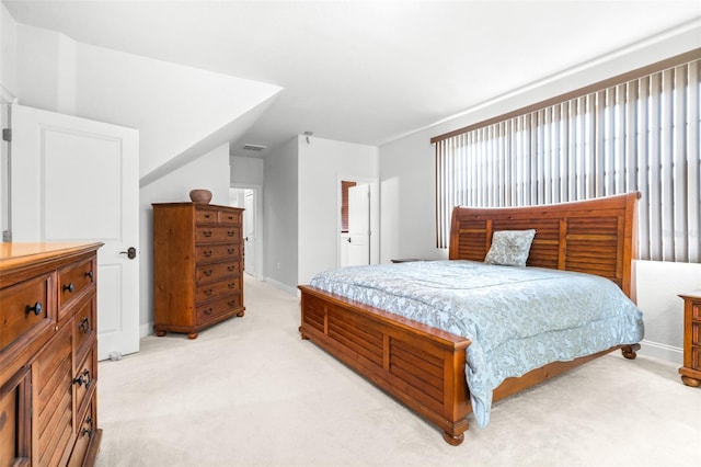 bedroom with visible vents, baseboards, and light colored carpet