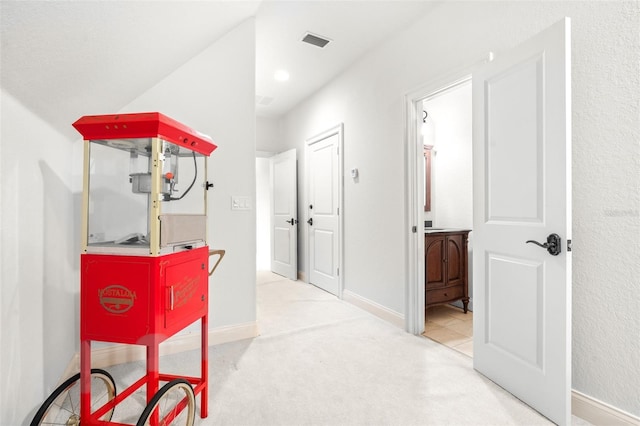 interior space with carpet, visible vents, and baseboards