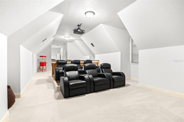 carpeted home theater featuring lofted ceiling, baseboards, and a textured ceiling