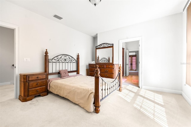carpeted bedroom featuring visible vents and baseboards