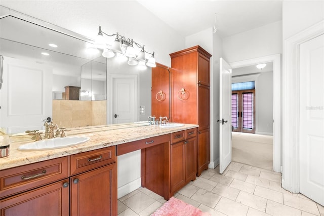 bathroom with double vanity, tile patterned flooring, and a sink