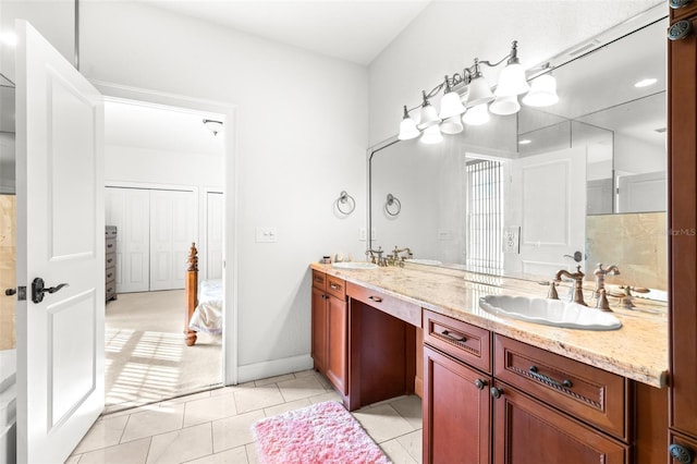 full bathroom featuring double vanity, a sink, and tile patterned floors