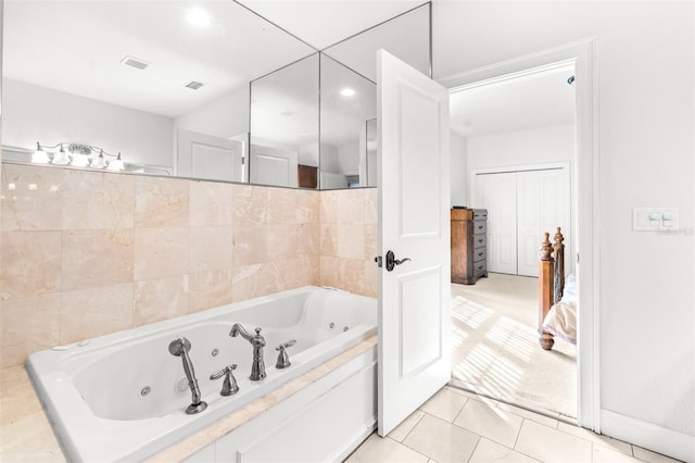 bathroom with a jetted tub, tile patterned flooring, and visible vents