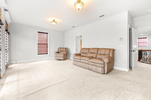 living area with carpet flooring, visible vents, and baseboards