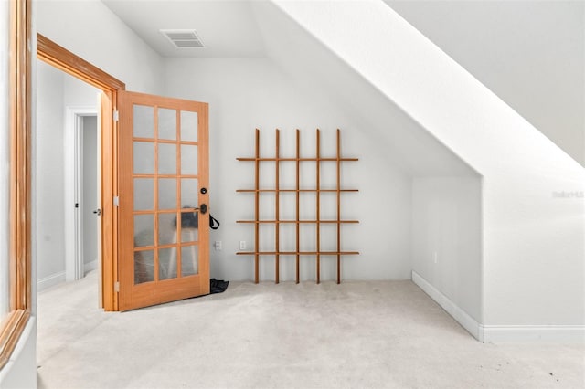 additional living space featuring carpet, visible vents, and vaulted ceiling