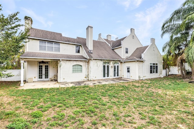 back of property featuring a yard, french doors, a patio area, and fence