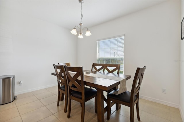 dining area with a notable chandelier, baseboards, and light tile patterned floors